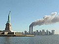 The statue with the World Trade Center on fire on September 11, 2001.