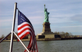 The statue with a United States flag in the foreground.